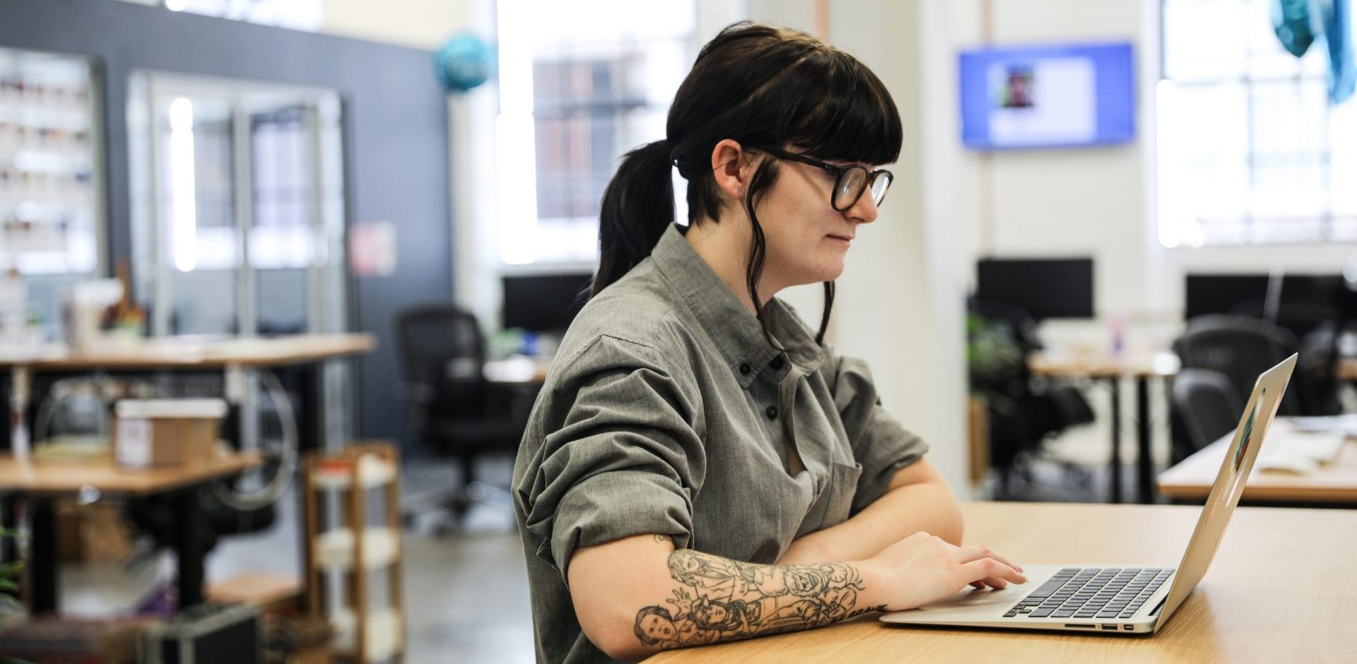 a woman business owner working on her computer