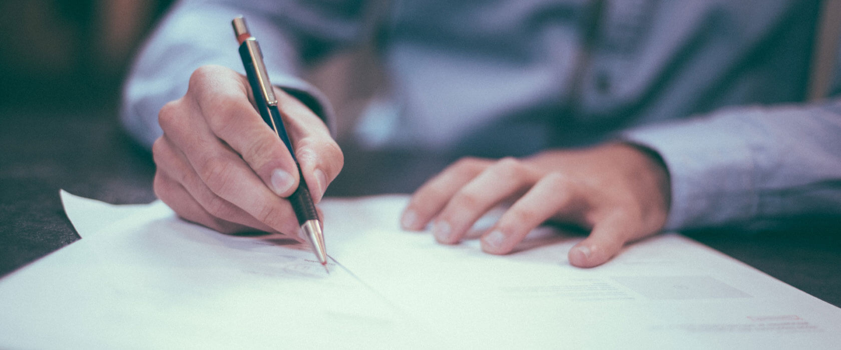 someone signing insurance papers